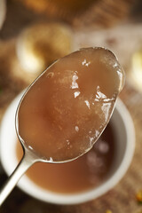 Homemade flax seed gel on a spoon - ingredient for natural diy shampoo. Alternative haircare, no poo.