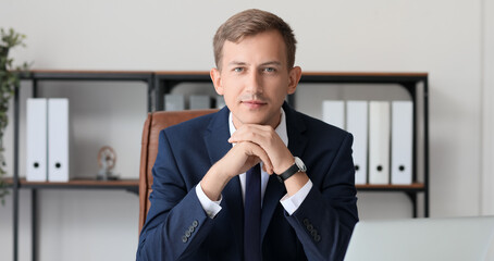 Young bank manager at table in office