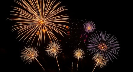 Obraz premium Bright orange and purple fireworks exploding in a dark night sky celebration