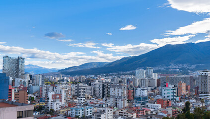 Panoramic view of the northern part of Quito during the afternoon with a blue sky