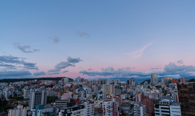 Panoramic view of the northern part of Quito during the afternoon with a red blue sky
