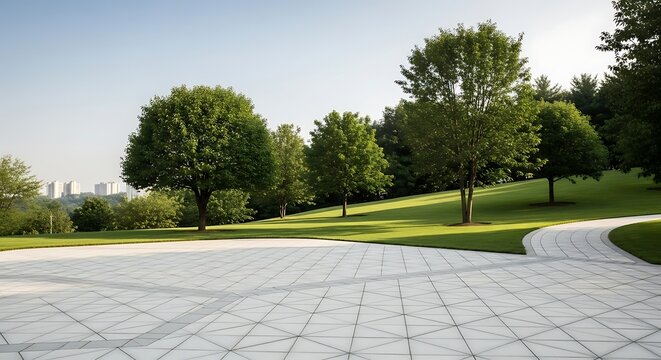 Manicured green lawn with trees and a geometric paved pathway leading towards distant buildings park