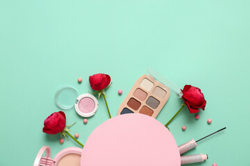 Blank card with cosmetics and red roses on turquoise background. Valentine's day celebration