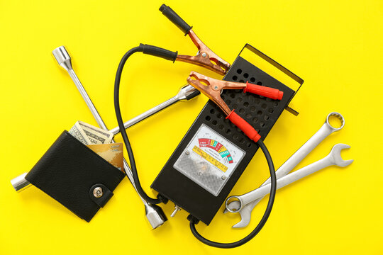 Electrician's supplies, wallet with money and credit card on yellow background