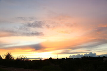 Beautiful bright orange sunset in the mountains with clouds