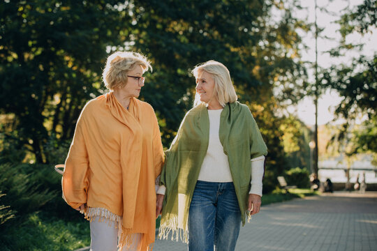 Two senior women enjoying a relaxing walk in the park