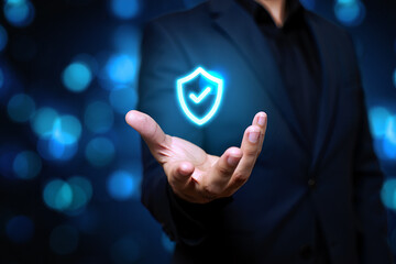 Businessman holding a glowing security shield icon