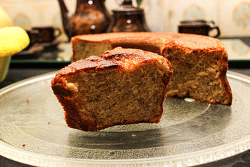 Banana Cake Slice Served on Glass Plate with Rustic Background