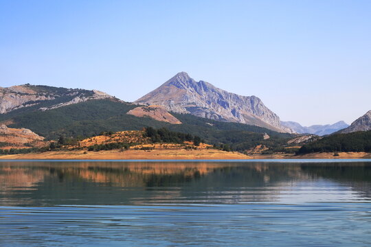 Pe&ntilde;a Susar&oacute;n Reflected in the Waters of Porma Reservoir