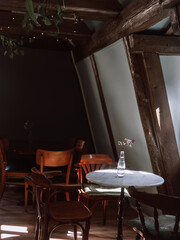 Small café table with bottle of water by window