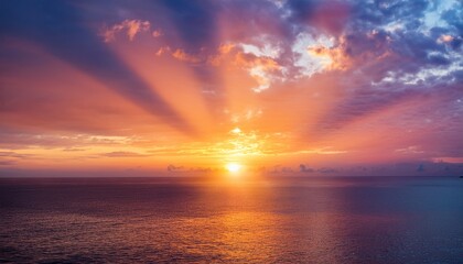 Obraz premium sight of sun radiant beams casting a palette of pink orange and gold across colorful seascape at daybreak