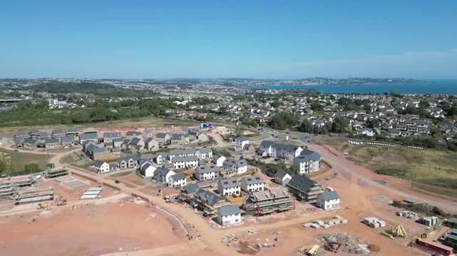 Paignton, South Devon, England: DRONE VIEWS: A new build housing development under construction on green belt land at White Rock. Paignton is a popular UK holiday resort (Clip 1 of 5).