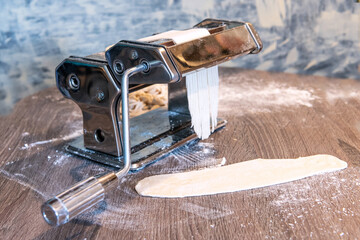 Rustic Kitchen Scene with Metal Pasta Maker and Flour-Dusted Countertop