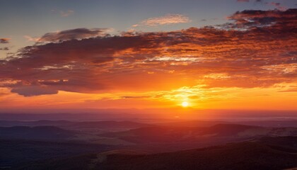 sunset glowing with warm hues blending soft cloudscape against serene landscape horizon