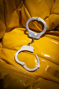 An extremely rare pair of Gucci handcuffs designed by Tom Ford. Crafted from solid 925 sterling silver and embellished with the Gucci logo on a yellow background. Milan, Italy, July 8, 2025