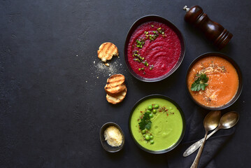 Delicious vegetable soups : carrot, green pea and beetroot. Top view with copy space.