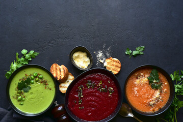 Delicious vegetable soups : carrot, green pea and beetroot. Top view with copy space.