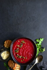 Beetroot soup with parmesan and croutons. Top vie with copy space.
