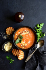 Carrot soup with parmesan and croutons. Top vie with copy space.