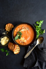 Carrot soup with parmesan and croutons. Top vie with copy space.