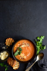 Carrot soup with parmesan and croutons. Top vie with copy space.