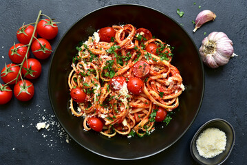 Pasta with grilled tomatoes. Top view with copy space.