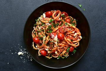 Pasta with grilled tomatoes. Top view with copy space.