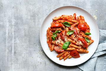 Pasta penne with grilled tomatoes. Top view with copy space.