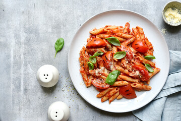 Pasta penne with grilled tomatoes. Top view with copy space.