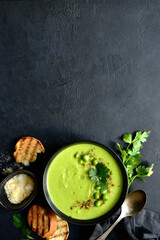 Green pea soup with parmesan and croutons . Top vie with copy space.