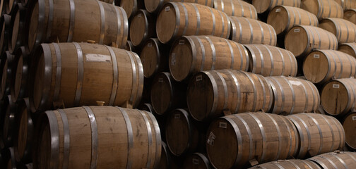 Stacked tequila barrels in Mexican cellar rustic wooden casks traditional beverage storage production authentic artisan