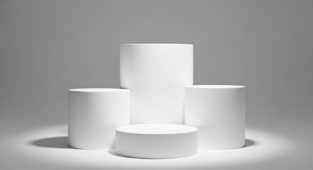 Three white cylindrical podiums on a gray background, showcasing a minimalist product display setup ideal for advertisement or branding mockups