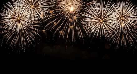 Golden fireworks burst against a dark night sky, creating a vibrant and celebratory scene, perfect for festive backgrounds or celebratory designs