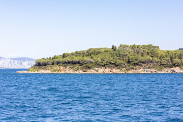 an Aegean island surrounded by forests and rocks
