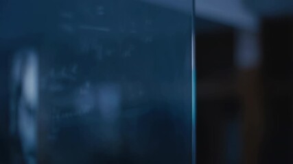 Futuristic glass display showing complex equations in empty office - Powered by Adobe