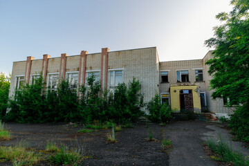 Old ruined overgrown abandoned school