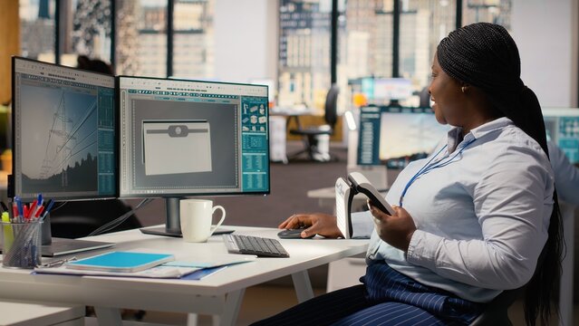 Engineer in office evaluating advanced solar cell technology clean energy based device. RD specialist turns lights on to test solar panel lamp prototype, checking power output, camera B