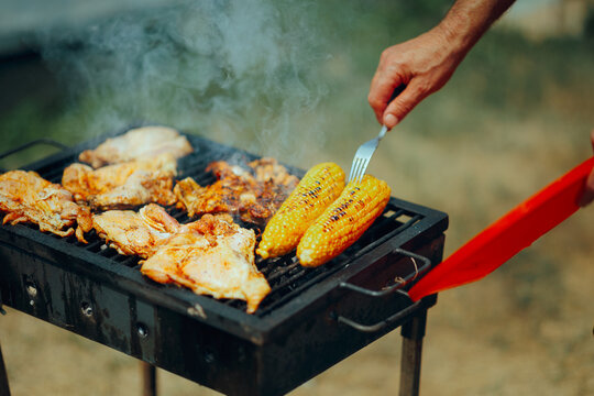 
Hand Turning over with a Fork he Meat and corn Grilling
Summertime traditional picnic snack grilling outdoor - Powered by Adobe