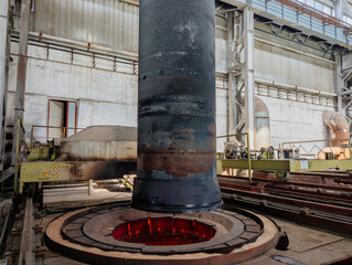 Hardening of pipe in special furnace, hot iron pipe on crane