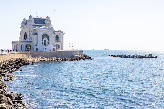 Historic constanta casino by the black sea with rocky shoreline and clear blue sky. May 3, 2025 Constanta Romania