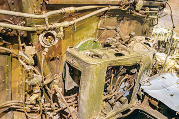 Close-up image of a crashed airplane part, showing metallic cylinder or pipe with rivets, extended...