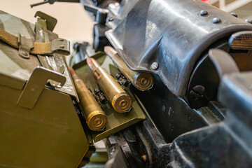Image of a green storage container filled with metallic rifle rounds, along with additional...