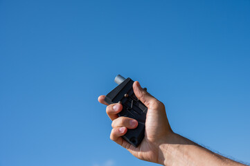 A man fires a flare gun with emergency fire. Close-up of a man's hand. 