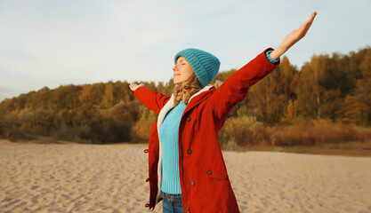 Happy relaxed smiling young woman on beach, enjoying amazing landscape, peace on sea coast