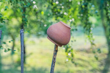 Close-up of a stationary pottery wheel in an ancient Central European village, surrounded by lush...