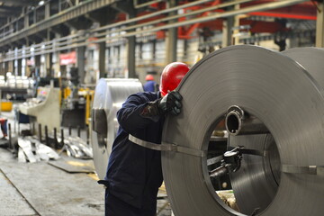 Workers on the production line of the strip steel coil factory are working