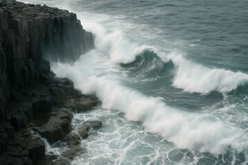 Powerful ocean waves crash against a dark, rocky cliff on a stormy day.