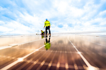 engineer man inspects construction of solar cell panel or photovoltaic cell by electronic device....