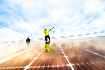 engineer man inspects construction of solar cell panel or photovoltaic cell by electronic device....