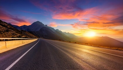 Fototapeta premium sunset road view from car with mountain silhouette and colorful sky